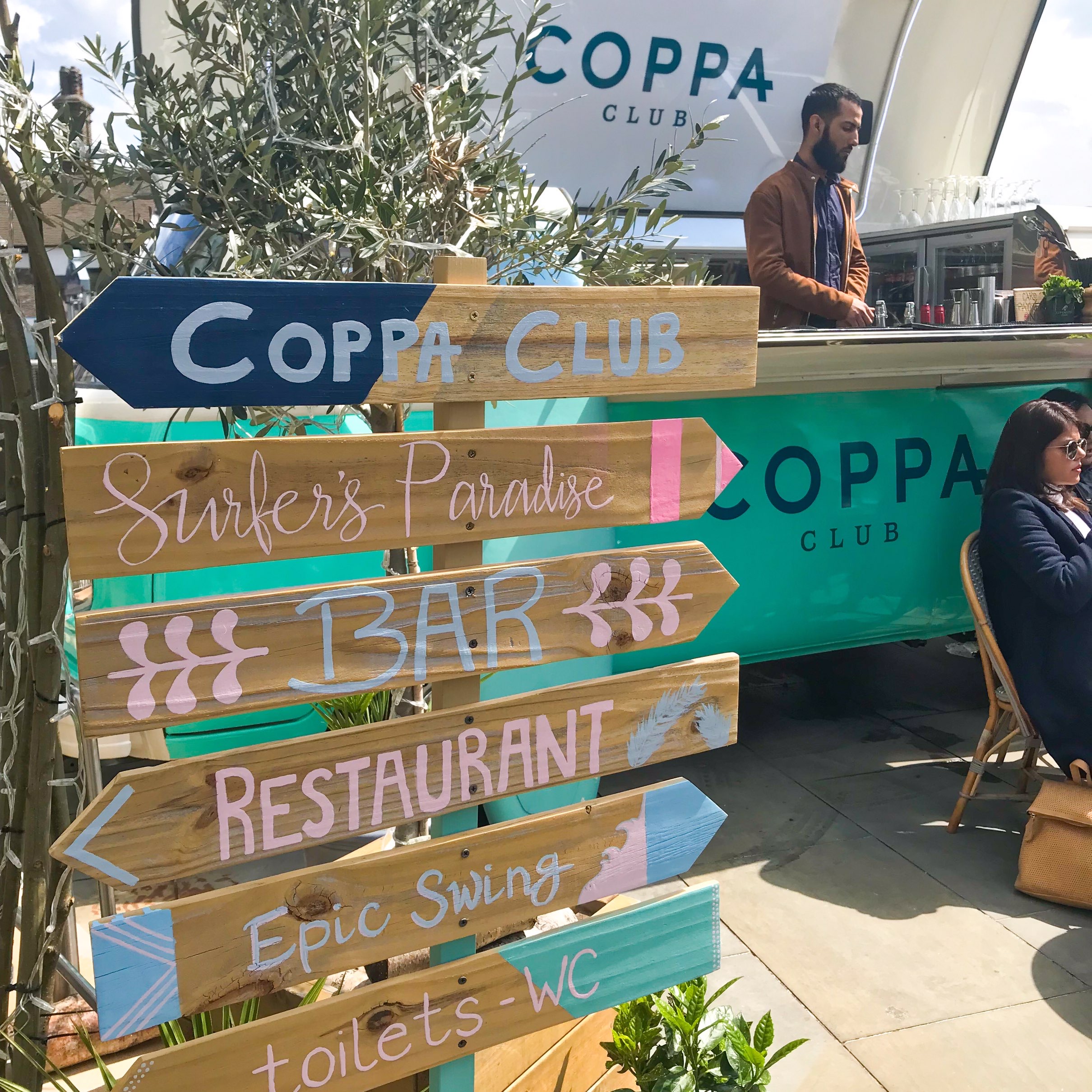 Surfer style signage outside the Coppa Club pods